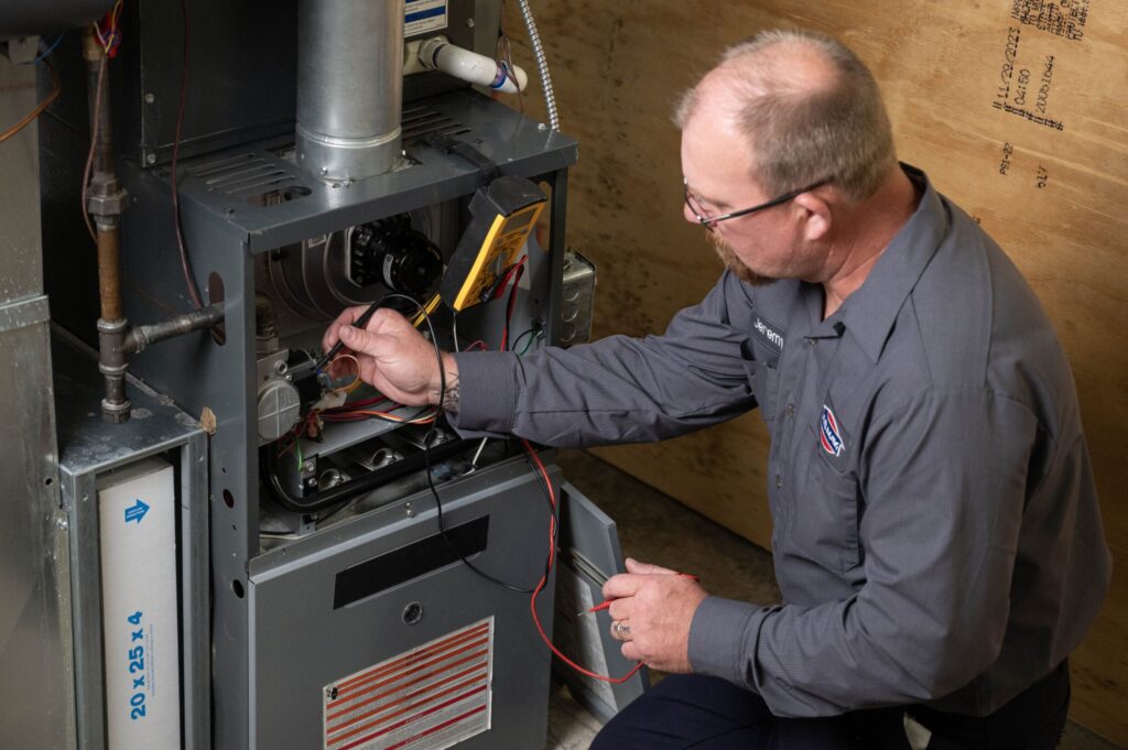 A.B. May technician working on a furnace
